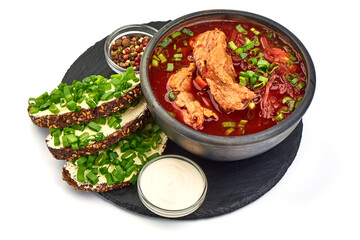 Traditional Ukrainian borscht with pork ribs, close-up, isolated on white background.