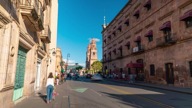 Morelia, Michoacan Mexico. OCT 2021. DOLLY IN. Av. Francisco I. Madero, in the background the Morelia Cathedral. Morelia is a historic and beautiful city, perfect for tourism. Hyperlapse day to night.
