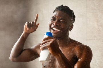 Black Guy Singing Having Fun In Shower Holding Shampoo Indoors