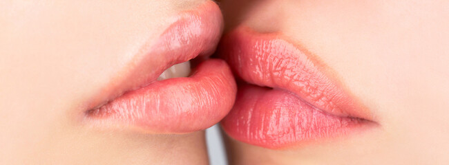 Closeup of beautiful young woman healthy lips. Lesbian couple kiss lips. Passion and sensual touch....