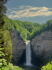 waterfall flowing into a deep pool at the base of the cliffs