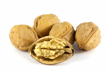 Broken walnut and oblong whole nuts isolated on white background.