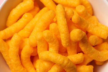 Closeup of a bowl of cheese doodles.