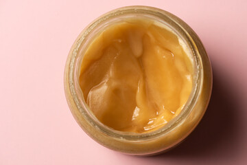 An opened can on honey viewed from above.