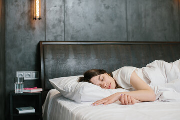 Woman sleeping in bed - stock photo