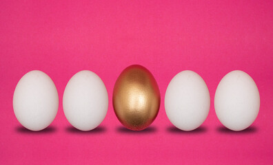 Concept of individuality, choices. One golden egg with white eggs pink background