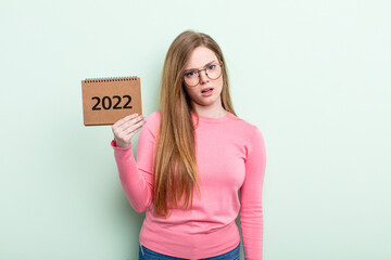 red head woman feeling puzzled and confused agenda 2022 concept