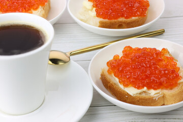Fototapeta na wymiar deluxe breakfast coffee and canapes with red caviar