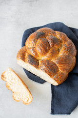 Homemade round challah with poppy seeds.