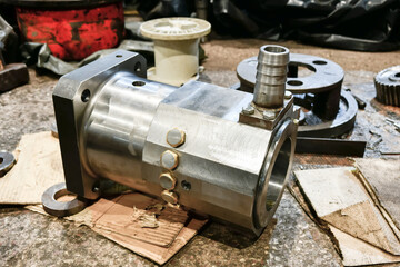 Ground cylinder of a hydraulic pump in a workshop being repaired.