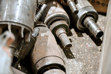Old disassembled internals of electric motors in a warehouse in a workshop.