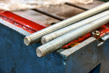 Long threaded studs in a repair shop before using joining parts.