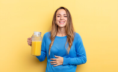 pretty woman laughing out loud at some hilarious joke orange juice concept