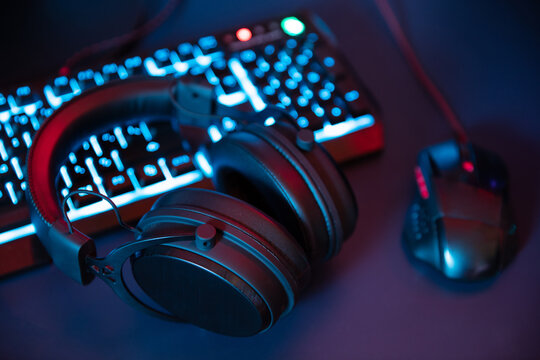 Modern gaming equipment lying on the desk in night