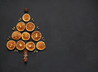 dried orange slices lai on a board with cinnamon sticks, top view. copy space