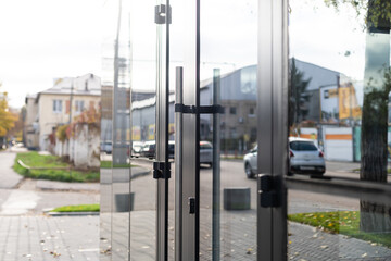 Outside solid glass door with building exterior