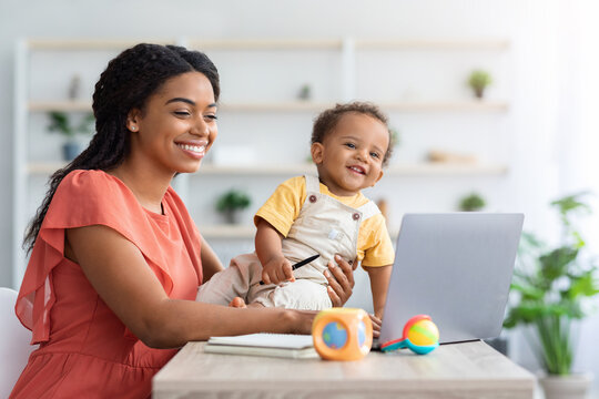 Portrait Of Happy Black Woman With Little Baby Using Laptop At Home