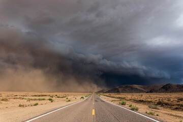 storm clouds over a road in the desert