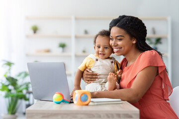 Black Woman Study With Laptop At Home And Taking Care About Child