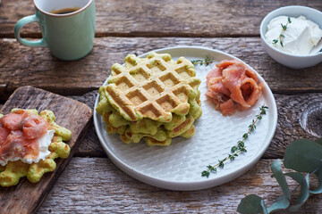 Belgian avocado waffles with salmon. Side view, wooden background. Rustic. 