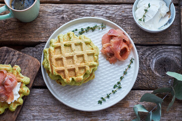 Belgian avocado waffles with salmon. Side view, wooden background. Rustic. 