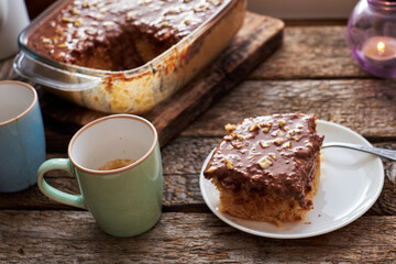homemade chocolate cake with nuts, side view, wooden background.