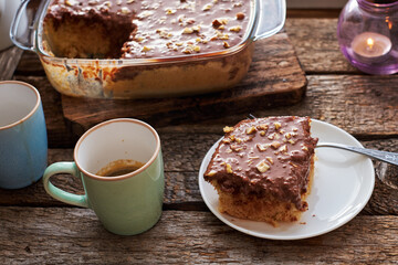 homemade chocolate cake with nuts, side view, wooden background.