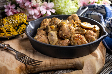 Meatballs served with pickled cucumber.