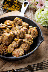 Meatballs served with pickled cucumber.