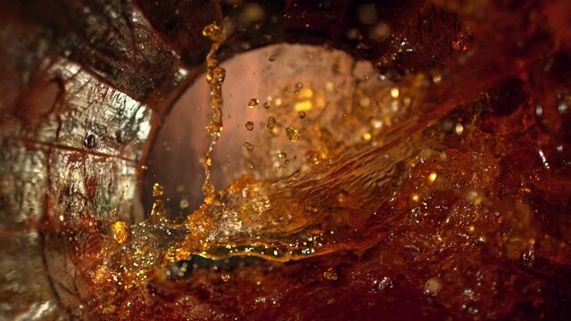Super Slow Motion Shot of Splashing Whiskey in Old Oak Barrel at 1000fps.