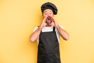 middle age man feeling happy,giving a big shout out with hands next to mouth. chef concept
