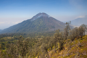 The mountain trail is shrouded in volcanic gas. Mountains on the island of Java, Ijen volcano.