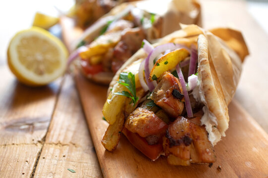 Greek Chicken Kebabs with Pita, Fries, Red onion, Tomato, Peppers, Feta, Olives and sauce
