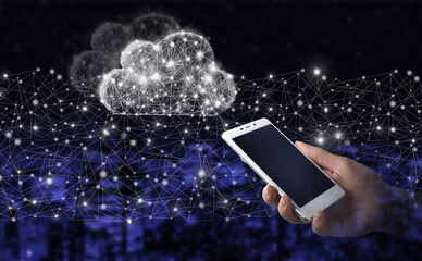 Cloud computing technology internet concept background. Hand hold white smartphone with digital hologram cloud sign on city dark blurred background.