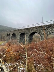 vintage stone railway bridge in autumn day