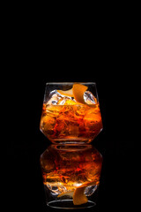 old fashioned cocktail on black background and reflection.