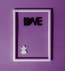 Angel of love in a white thin frame on purple background