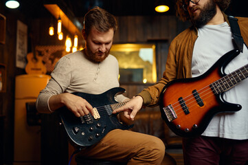 Hipster guys training play guitar enjoy rehearsal