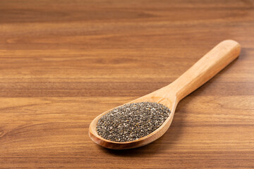 Chia seeds in wooden spoon.