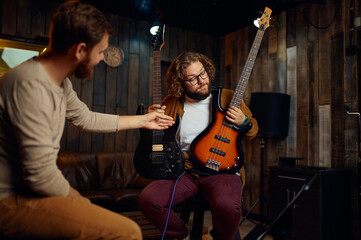 Student asking teacher about guitar at lesson