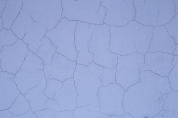 Old retro scratched cracked white grey light blue painted plaster stucco wall background texture.
