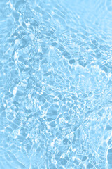 Fresh water background. Bright blue pattern with natural rippled water texture and bubbles. Top view with copy space. Clear water surface background.