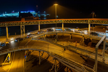 Ferry terminal and linkspan to the ro-ro ship in the harbor of Ystad at night. The ferry connects...