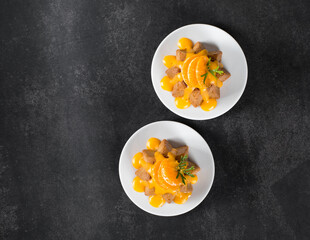 Spiced citrus cake with icing sugar on a plate on a dark gray background. Top view. Copy space