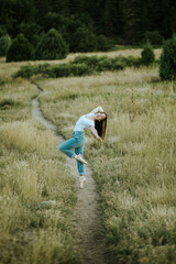 ballerina dancing on pointe in field outside