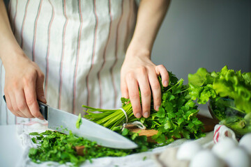Anonymous woman chopping parsley / cilantro