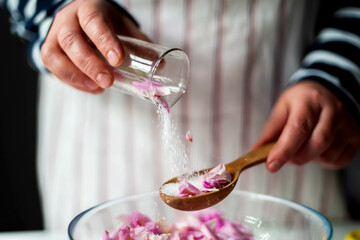 Woman Making Pink Rose Petal Jam in kitchen