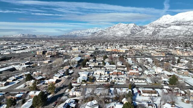 Drone shot of beautiful snow covered city with snow mountain landscape
