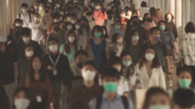 Defocused, Large crowd of business people with medical face mask. Air pollution. Coronavirus, covid 19 quarantine, 