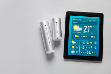 Weather forecast equipment and tablet computer on light background with space for text